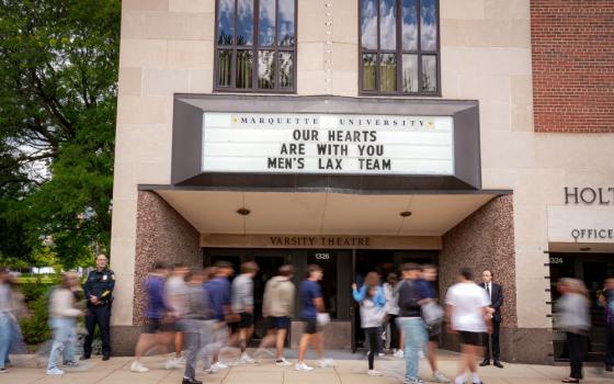 An overflow crowd packed the theater and lobby of Marquette University's Varsity Theatre for a memorial Mass for two college lacrosse players killed in a crash by alleged drunken driver Sept. 6. (Clay Ellis-Escobar)