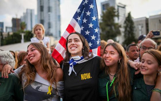 Young women embrace as people gather at Hostage Square in Tel Aviv, Israel, to celebrate after U.S. President Donald Trump announced that Israel and Hamas agreed on the first phase of a Gaza ceasefire Oct. 9, 2025. (OSV News/Reuters/Shir Torem)