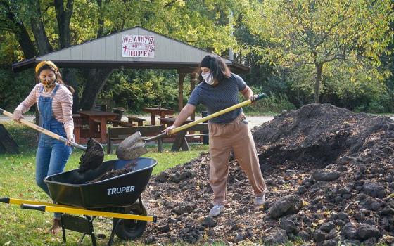 People work on a garden at Sacred Heart Parish Mission in the Diocese of Joliet, Ill. The food grown is distributed to people in need of food assistance in the community. (CNS/Courtesy of Joliet Diocese)