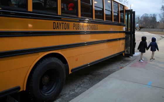 A file photo shows a public school bus dropping students off at an elementary school in Dayton, Ohio. (OSV News/Reuters/Megan Jelinger)