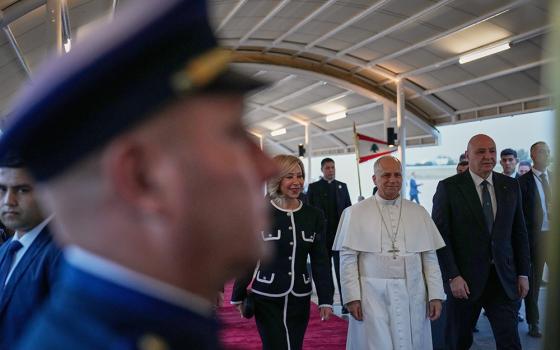 Pope Leo XIV, center right, is escorted by Lebanese President Joseph Aoun, right, and First Lady Nehmat Aoun after his arrival at Beirut International Airport in Beirut, Lebanon on Nov. 30, 2025. (AP Photo/Hussein Malla)