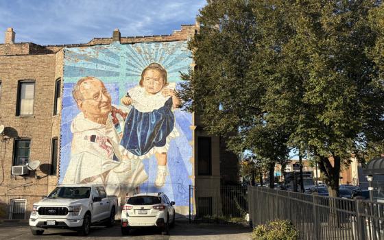 An old mural depicting the founder of The Resurrection Project, Dominican Fr. Charles Dahm, in Pilsen, Chicago's Mexican neighborhood. (NCR photo/Camillo Barone)