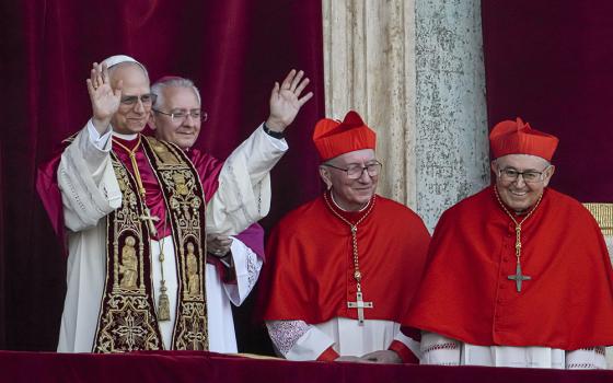Newly elected Pope Leo XIV, left, formerly Cardinal Robert Francis Prevost, appears with, from left, Archbishop Diego Giovanni Ravelli, master of ceremonies; Cardinal Pietro Parolin; and Bosnian Cardinal Vinko Puljić on the central loggia of St. Peter's Basilica at the Vatican, shortly after he was elected pope, Thursday, May 8, 2025. (AP photo/Domenico Stinellis)