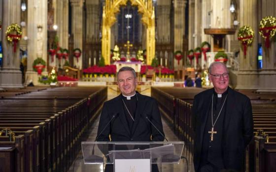 New York Archbishop Timothy Dolan, right, welcomes Bishop Ronald Hicks during a news conference at St. Patrick's Cathedral, Dec.18. in New York. 