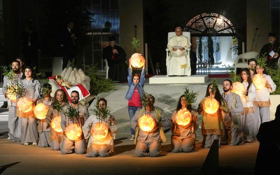 Pope Leo XIV watches a performance by youths holding illuminated globes during an event in Bkerki, the seat of the Maronite Church, in Lebanon Dec. 1, 2025. (AP/Domenico Stinellis)