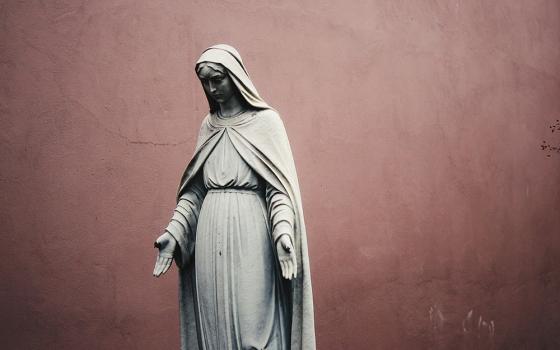 A photo shows a gray statue of Mary. (Unsplash/Jon Tyson)