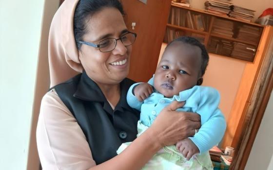 Sr. Alphonsa Parathur, of the Society of Helpers of Mary, poses with a child who was recently welcomed into the Holy Family Children's Home in Nakuru, Kenya. Parathur manages the home. (Courtesy of Alphonsa Parathur)