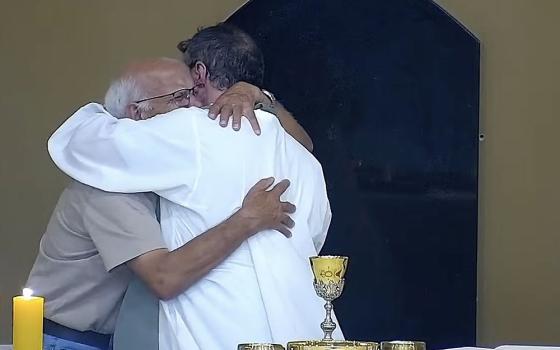 Fr. Carlos Henrique Fernandes of the Diocese of Tubarão, Brazil, right, embraces a crying elderly man named Marcos who approached the altar moments before Communion at the Church of St. Francis of Assisi in Tubarão Jan. 18, 2026. (OSV News/Communications Pastoral Ministry via YouTube)