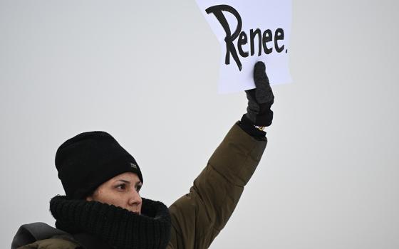  A protester holds up a sign reading "Renee", the woman shot and killed by a U.S. Immigration and Customs Enforcement officer in Minneapolis on Wednesday, outside the Bishop Henry Whipple Federal Building, Thursday, Jan. 8, 2026, in Minneapolis, Minnesota. (AP photo/Tom Baker)