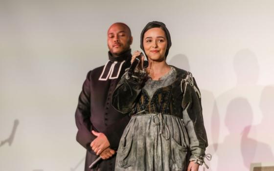 Eyma Scharen (Bernadette Soubirous) performs at a December press event to announce the U.S. premiere of "Bernadette, The Musical." Behind her is Thomas James (Fr. Peyramale). The show premieres Feb. 19 at the Athenaeum Center for Thought & Culture in Chicago. (Courtesy of Maija Martin)