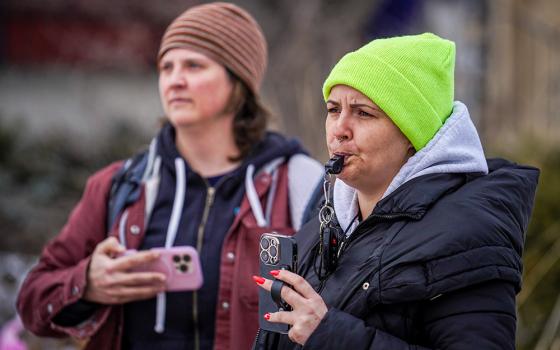 Observers blow their whistles while federal agents conduct immigration enforcement operations on Feb. 5, 2026, in Minneapolis. (AP/Ryan Murphy)