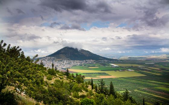 Clouds pass over Mount Tabor in the distance in Galilee, Israel. The mount is traditionally known as the site of Jesus' transfiguration. (Wikimedia Commons/Reutmaor)