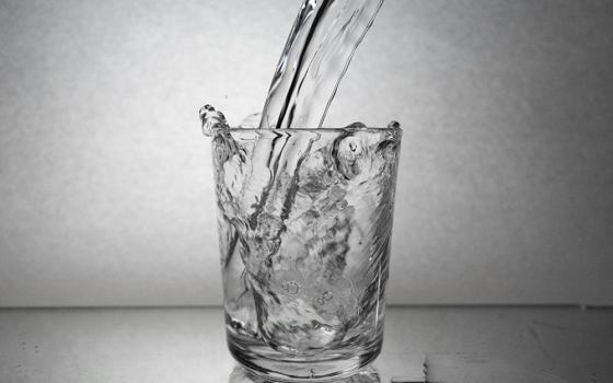 Water being poured into a glass (Unsplash/Siyavash Lolo)