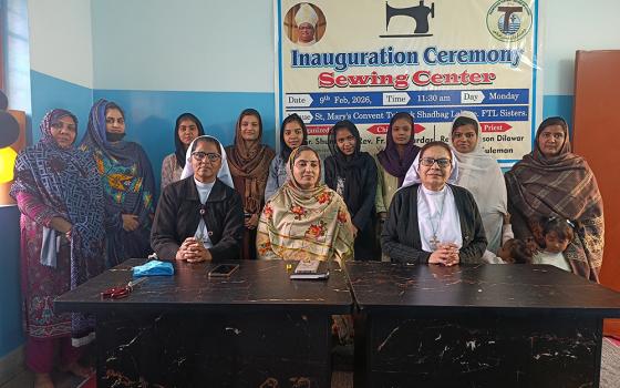 Srs. Mercy Lal, right, and Cecilia Joseph, left, pose with a group of trainees at their sewing center in Lahore, Pakistan. (Kamran Chaudry)