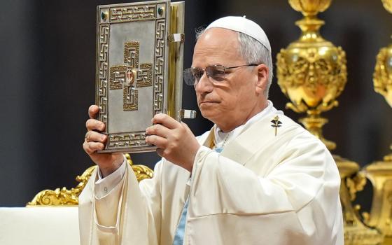 Pope Leo XIV elevates the Book of the Gospels during Mass marking the Jubilee of the Holy See in St. Peter’s Basilica at the Vatican June 9, 2025. (CNS/Lola Gomez)