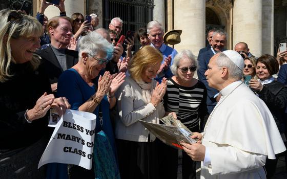 Pope Leo XIV meets with former classmates who graduated from the lower school of St. Mary of the Assumption in Chicago in 1969 after the general audience in St. Peter's Square at the Vatican March 18, 2026. (CNS/Vatican Media)