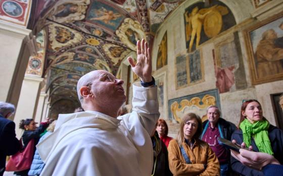 Friar Daniele Aucone, foreground, deputy director of the Basilica of Santa Maria Sopra Minerva, guides journalists through the basilica's cloister in Rome March 18, 2026. St. Catherine of Siena and the Renaissance painter Fra Angelico, both of whom are buried in the basilica. (AP/Domenico Stinellis)