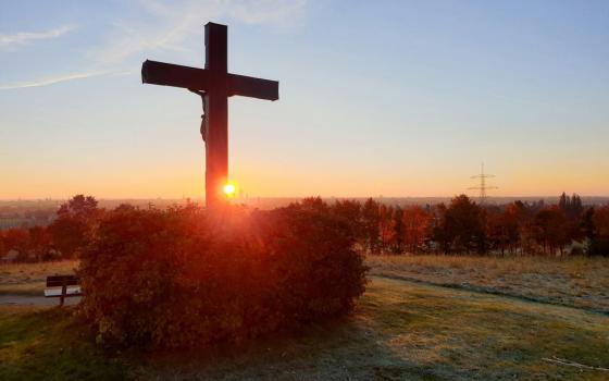 Back of crucifix silhouetted against sky
