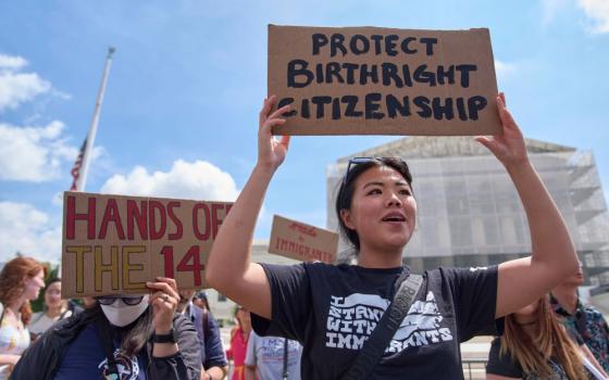 Hannah Liu, 26, of Washington, holds up a sign in support of birthright citizenship, May 15, 2025, outside the Supreme Court in Washington, D.C. (AP/Jacquelyn Martin)