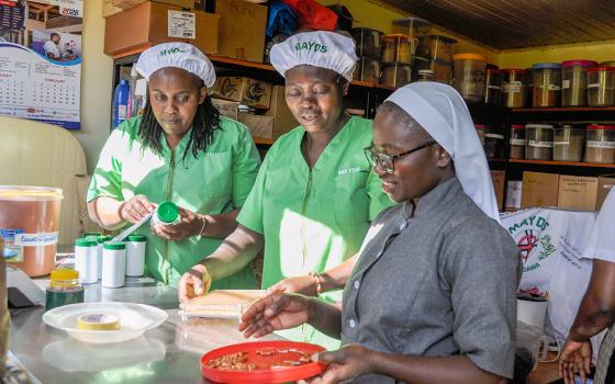 Sr. Mary Grace, a postulant of the Missionary Benedictine Sisters, and staff make cayenne pepper capsules at the Medicine at Your Door Step production unit  in Karen, Nairobi, Kenya. (Lourine Oluoch)