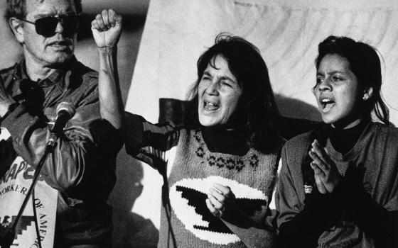 United Farm Workers leader Dolores Huerta, center, leads a rally in San Francisco's Mission District on Nov. 19, 1988, along with Howard Wallace, left, president of the San Francisco chapter of the UFW, and Maria Elena Chavez, right, the daughter of César Chavez. (AP/Court Mast, File)