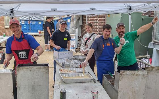 A team of parishioners cook fish at the annual Lenten fish fry at St. Margaret of Scotland Catholic Church, in St. Louis, March 21, 2023. This year, with the help of a grant from the St. Louis Archdiocese's Laudato Si' Commission, the parish for the first time will compost leftover food and compostable materials in an effort to reduce waste. (St. Margaret of Scotland Catholic Church)