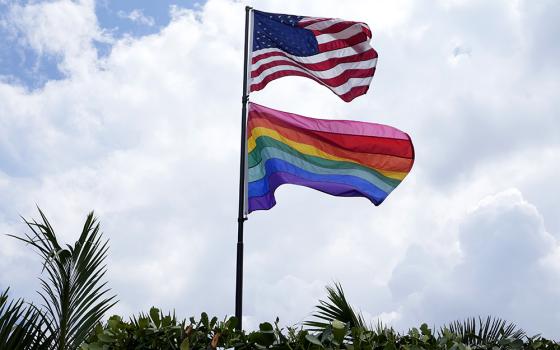 An American flag flies with a pride flag outside of a home in Wilton Manors, Fla., Thursday, June 29, 2023. (AP photo/Lynne Sladky)