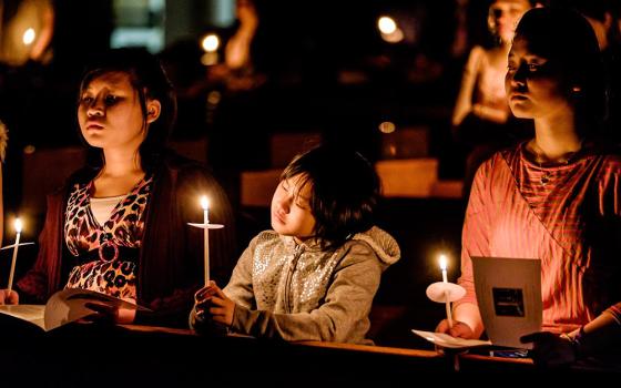 Young people hold candles during the Easter Vigil at the Cathedral of St. Joseph in Hartford, Conn., in 2015. (CNS/Bob Mullen)