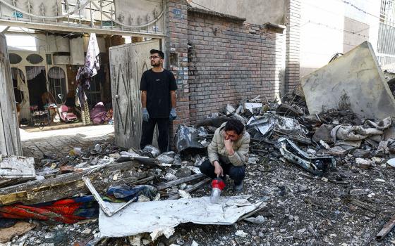 People react at the site of a residential building in Tehran, Iran, March 27, 2026, that was damaged by a strike amid the U.S.-Israeli war with Iran. (OSV News/West Asia News Agency via Reuters/Majid Asgaripour)