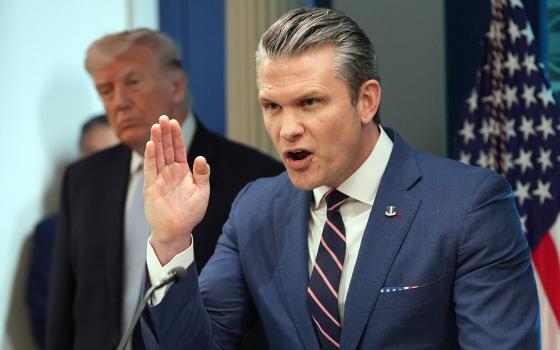 Defense Secretary Pete Hegseth speaks with reporters in the James Brady Press Briefing Room at the White House April 6 in Washington, as President Donald Trump looks on. (RNS/AP/Alex Brandon)