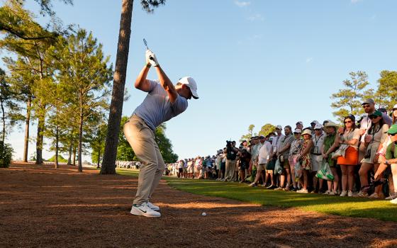 Rory McIlroy, of Northern Ireland, hits from the pine straw on the 18th hole during the final round of the Masters golf tournament at the Augusta National Golf Club, Sunday, April 12, 2026, in Augusta, Georgia. (AP photo/Gerald Herbert)