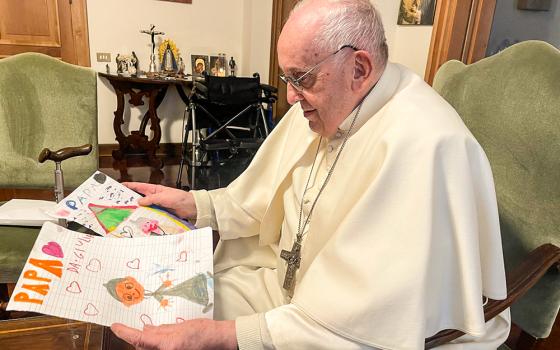 Pope Francis receives drawings from the children of Vatican News journalist Salvatore Cernuzio at Casa Santa Marta, Vatican City, June 2022. (Courtesy of Salvatore Cernuzio)