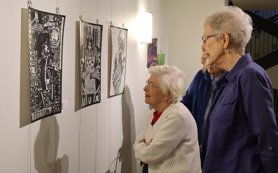 Srs. Betty Leon and Monica Stuhlreyer view artwork on display at the Prison Creative Arts Project's exhibition at the Sisters, Servants of the Immaculate Heart of Mary's Motherhouse Gallery. (Courtesy of Kameryn Gannon/IHM Sisters)