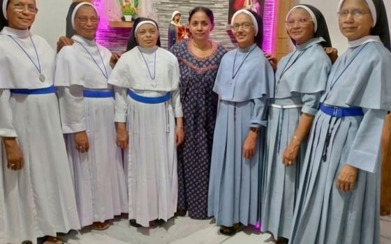 The Kallidukkil sisters pose with their youngest sister, Pauline Kallidukkil, at her residence in Valillapuzha, Kerala, southwestern India. Pauline Kallidukkil is at center. On her right are Srs. Gracious Kallidukkil, Ancy Kallidukkil and Philo Kallidukkil; on her left are Srs. Jacintha Kallidukkil, Mareena Kallidukkil and Rosetom Kallidukkil. (Courtesy of Philo Kallidukkil)