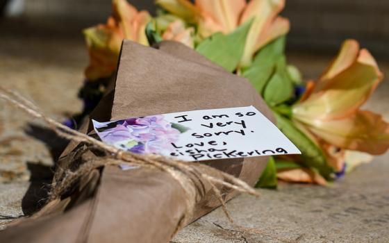 A note attached to a bundle of flowers left outside the Beth Israel Congregation reads, "I am so very sorry," on Jan. 12, 2026, in Jackson, Miss., after an arson attack significantly damaged the synagogue, the oldest in Mississippi. (AP/Sophie Bates)