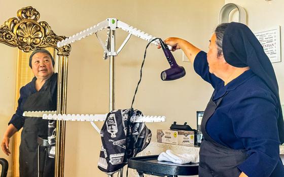Daughter of Charity Sr. Oanh Tran cleans up her hair styling station at the Fr. Virgil Cordano Center June 10, 2026, in Santa Barbara, California. (GSR photo/ Rhina Guidos)