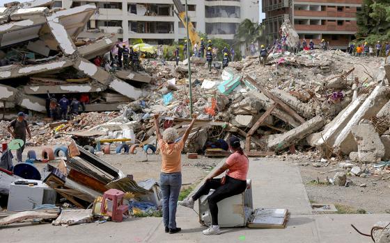 A woman prays as people work together to search for their loved ones amid debris in La Guaira, Venezuela, July 20, 2026, following the aftermath of the June 24 earthquakes. (OSV News/Reuters/Gaby Oraa)