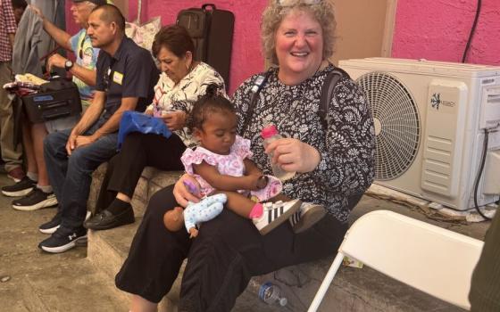 Society of the Sacred Heart Sr. Lisa Buscher smiles at another sister after feeding a child at the Cobina Posada del Migrante shelter in Mexicali, Mexico, June 6, 2026. (GSR photo/Rhina Guidos)