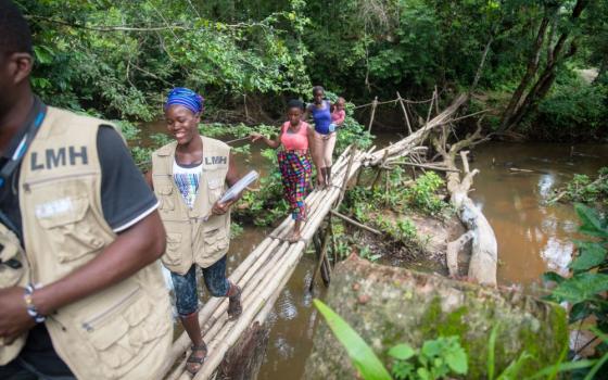 In Liberia, nearly 30% of the population lives more than 5 kilometers (3 miles) from the nearest health facility. Since 2007, Last Mile Health has partnered with the Ministry of Health to build a workforce of community health workers who cross footbridges and canoe rivers to bring life-saving care to remote communities. The group now serves every county nationwide. (©Last Mile Health)