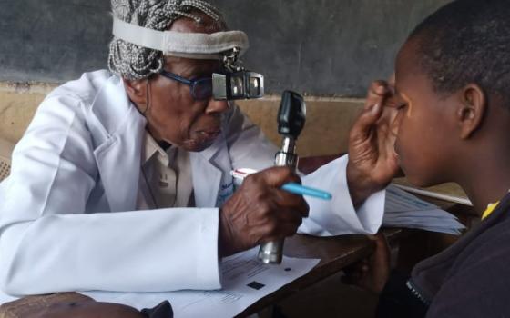 Dr. Sr. Marlene Long gives a patient an eye exam during the Primary School Eye Health Project in Ngong, Kenya in the early 2000s. (Courtesy of Marlene Long)