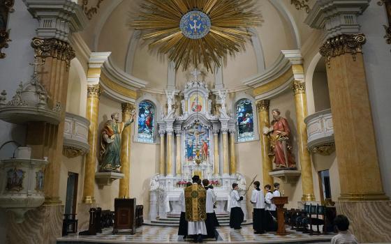 Fr. John Ubel, pastor of the Church of Saint Agnes, processes into the sanctuary with altar servers at the start of one of the Catholic parish's Latin Masses in St. Paul, Minn., June 28, 2026. (RNS/AP/Giovanna Dell'Orto)