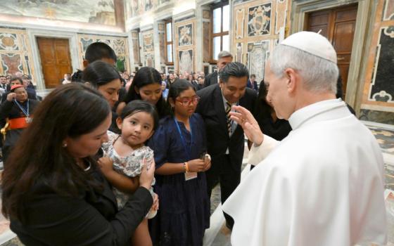 Pope Leo XIV blesses a child as he meets with participants of the XVII Annual Meeting of International Catholic Legislators Network at the Vatican Aug. 21, 2026. (OSV News/Vatican Media/Matteo Pernaselci) 