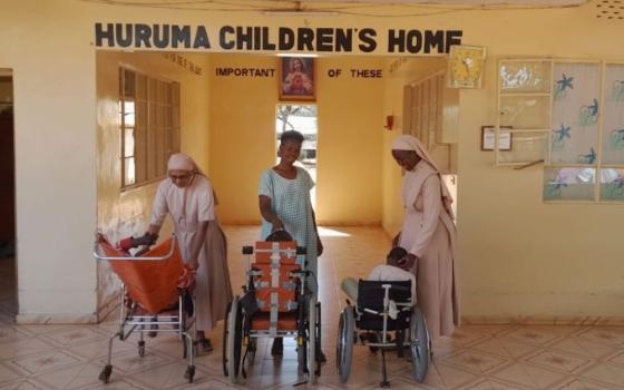 Srs. Rosily Kokkaden, Sr. Anne Hiuhu and staff member Beatrice Lesayeiye interact with children at Huruma Children's Home in Wamba, Kenya. (Lourine Oluoch)
