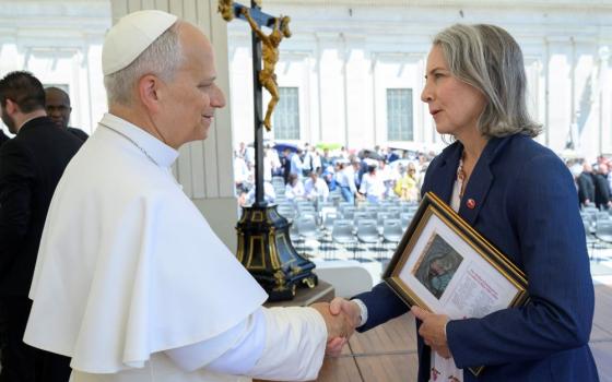 Krisanne Vaillancourt Murphy meets Pope Leo XIV on June 17, 2026, and gives him a framed drawing from a man on Ohio's death row with 28 names of men who have scheduled execution dates. (Courtesy of Vatican Media)