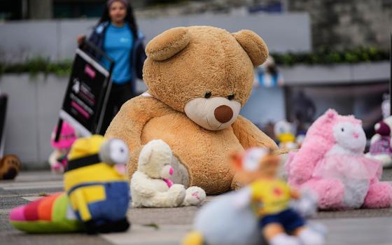 Toys are displayed outside the prosecutor's office in a symbolic act seeking to draw the attention to child sexual abuse in Bogotá, Colombia, Nov. 20, 2025. (AP/Fernando Vergara)
