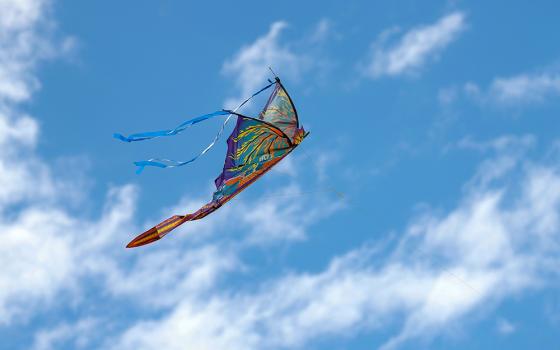 Butterfly shaped kite flying in the sky (Unsplash/Liz Morgan)