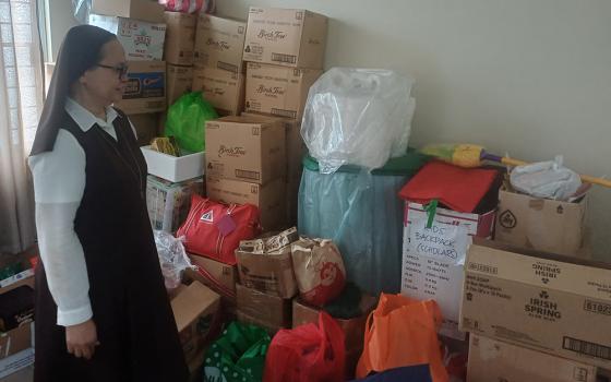 Sr. Milaluna Moralde Arranchado checks donated food, clothing and other supplies for homeless people served by the Carmelite Missionaries in Quezon City, Philippines. (Oliver Samson)