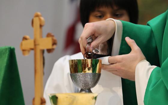 A priest is seen in a file photo pouring wine into the chalice during the offertory of the liturgy of the Eucharist as he celebrates morning Mass. (OSV News/Bob Roller)