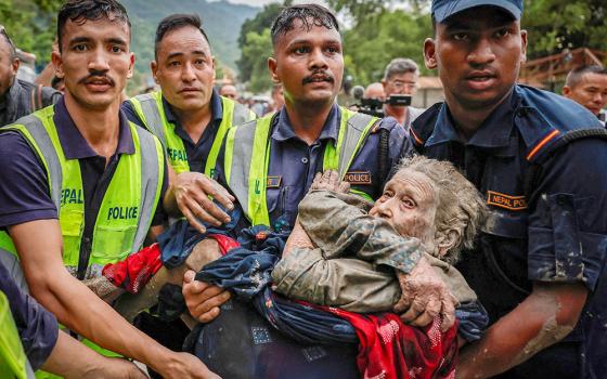 Police officers carry an elderly survivor to a safer place at Devighat in Nepal's Nuwakot district, Aug. 30, 2026, following deadly flash floods and mudslides. (OSV News/Reuters/Navesh Chitrakar)