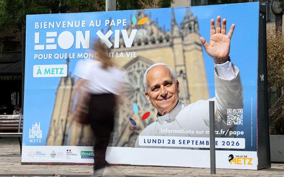 A woman walks past a poster in front of the train station in Metz, France, Sept. 9, 2026, welcoming Pope Leo XIV ahead of his visit in the northeastern French city. (OSV News/Reuters/Ardee Napolitano)